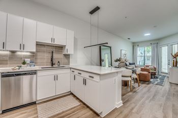 Open concept kitchen with white cabinets and island